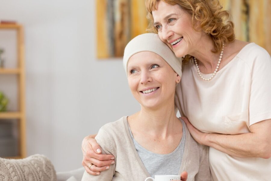 Cancer patient and woman in a warm embrace